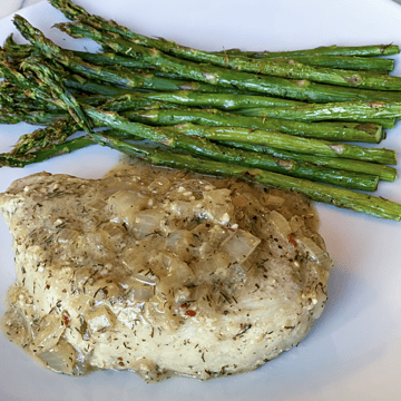 Dijon Pork Chops with asparagus on white plate