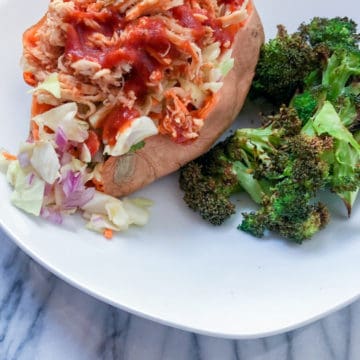 BBQ chicken stuff in a sweet potato with coleslaw and broccoli