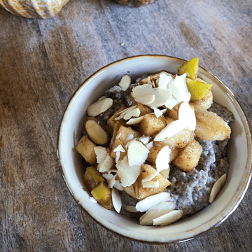 Cinnamon chia seed pudding in a bowl with apples and bananas