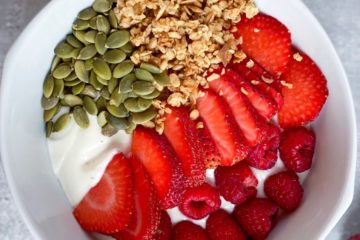 Dairy-free yogurt parfait with strawberries, raspberries, granola and pumpkin seeds