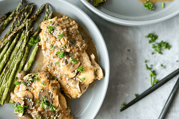 One Pan Chicken Marsala on a plate with asparagus