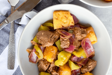Easy deconstructed kabobs with beed, bell peppers, onions and pineapple in a white bowl.