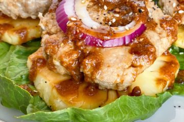 Teriyaki Chicken Burgers with onion, slice of pineapple over bib lettuce