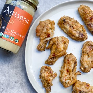 spicy cashew butter wings on a plate with cashew butter