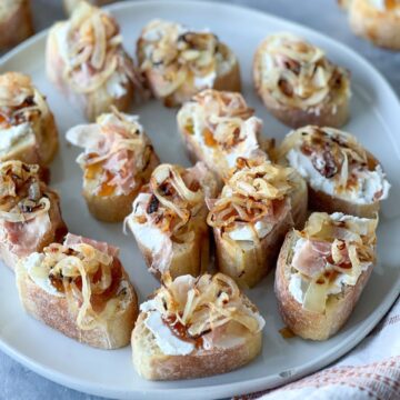 Gluten-free caramelized onion crostinis on a plate