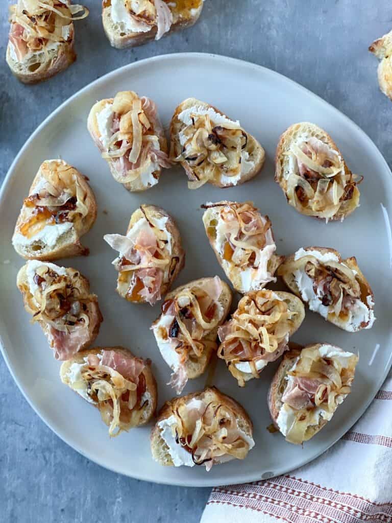 Gluten-free caramelized onion crostinis on a plate