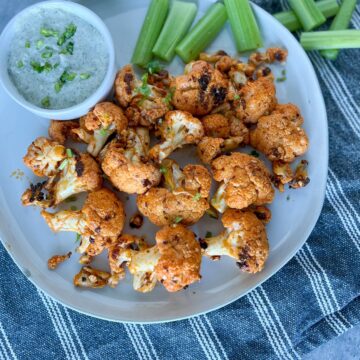 Buffalo Cauliflower on a plate with ranch and celery