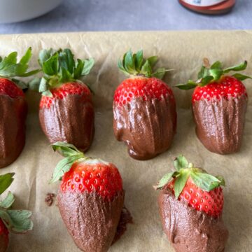 Easy chocolate covered strawberries on parchment paper