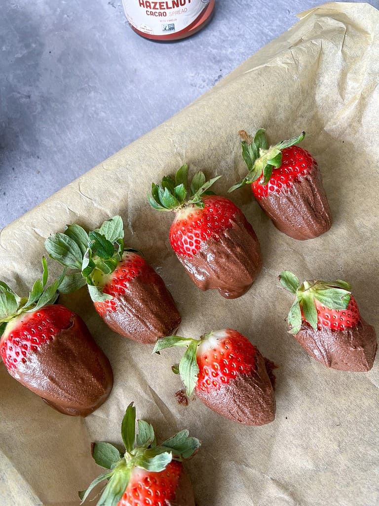 Easy chocolate covered strawberries on parchment paper