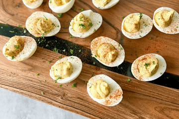 healthy deviled eggs on a wood plank