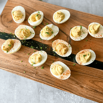 healthy deviled eggs on a wood plank