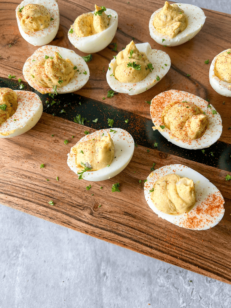 deviled eggs on a wood plank